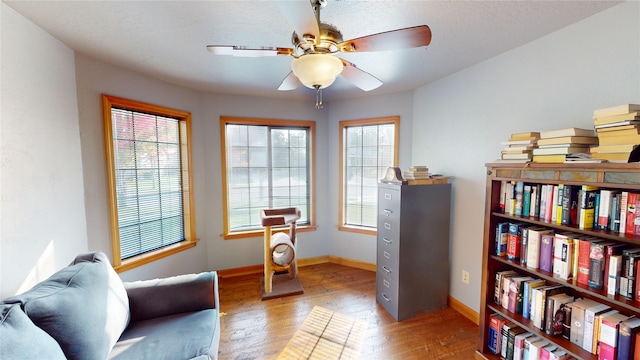 sitting room with light hardwood / wood-style flooring, a wealth of natural light, and ceiling fan