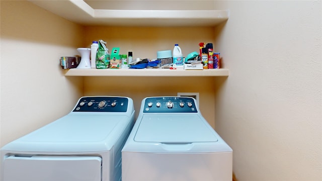 clothes washing area with washer and dryer