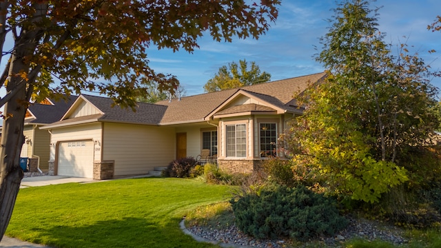 view of front of property with a garage and a front lawn