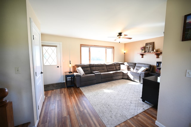 living room featuring ceiling fan and dark hardwood / wood-style flooring