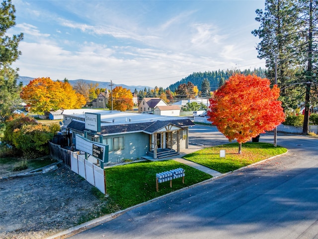 exterior space featuring a mountain view and a front lawn