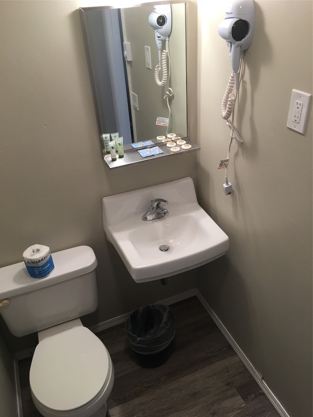 bathroom with ornamental molding and toilet