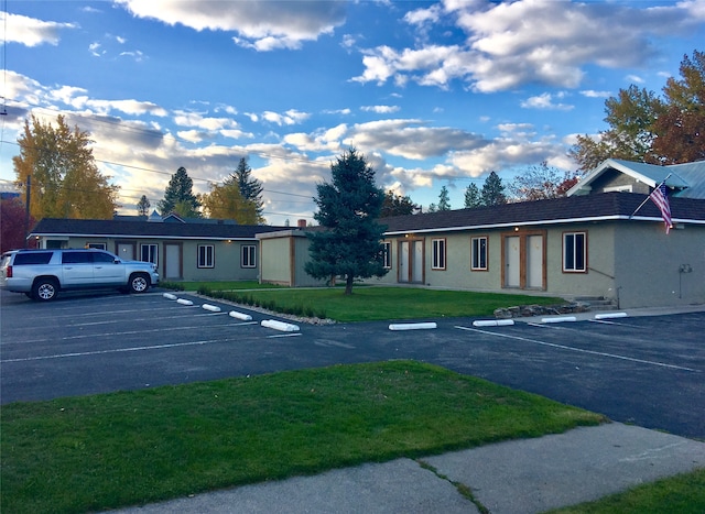 view of vehicle parking featuring a lawn