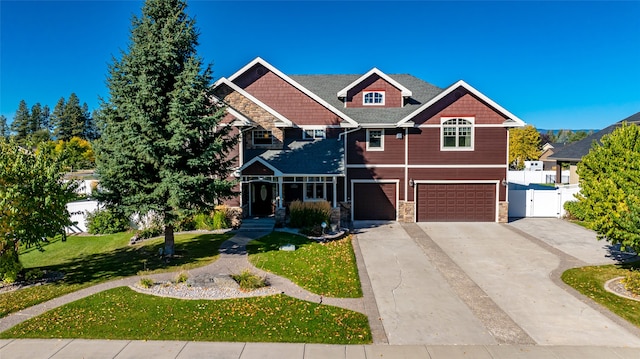 craftsman-style home featuring a garage and a front lawn