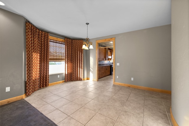 unfurnished dining area featuring a notable chandelier and light tile patterned floors