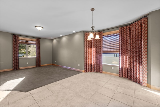 tiled empty room featuring a notable chandelier