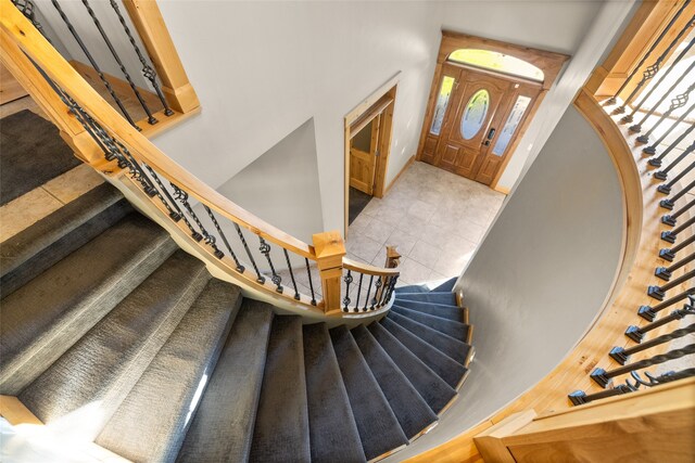 stairway with tile patterned floors