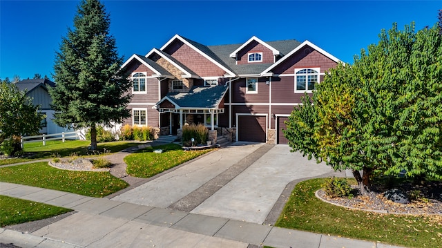 craftsman inspired home with a front yard and a garage