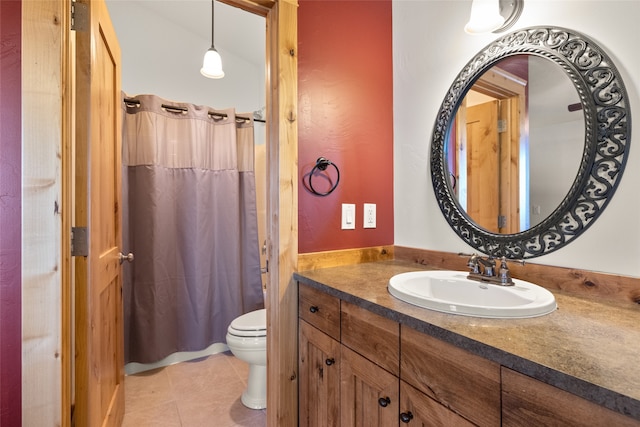 bathroom featuring vanity, tile patterned flooring, toilet, and curtained shower