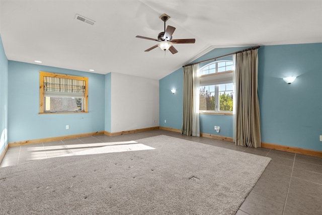 unfurnished room with ceiling fan, lofted ceiling, and tile patterned floors