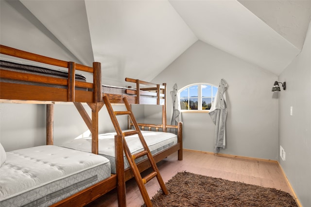 bedroom featuring wood-type flooring and lofted ceiling