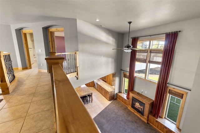 tiled living room with ceiling fan