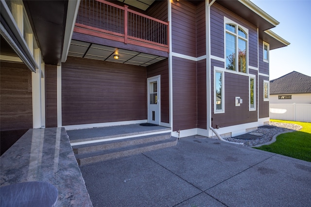 view of property exterior with a patio and a balcony