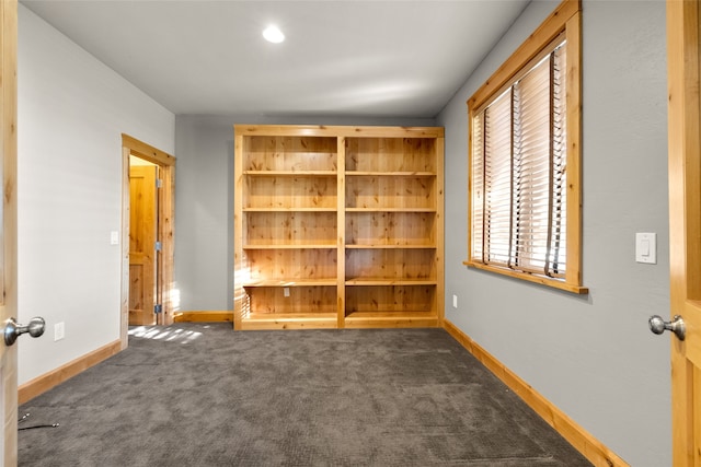 unfurnished bedroom featuring dark colored carpet