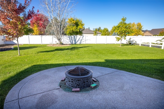 view of yard featuring a patio and an outdoor fire pit