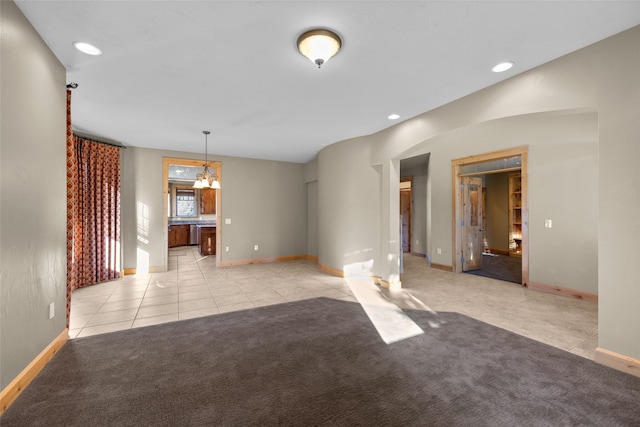 interior space with a notable chandelier and light carpet