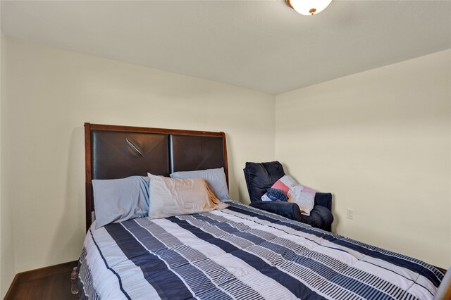 bedroom with hardwood / wood-style floors