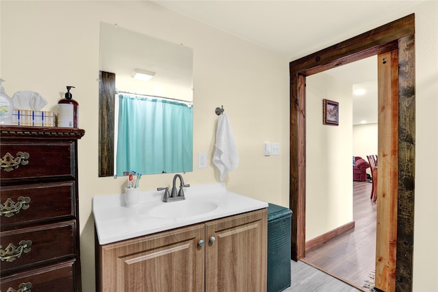 bathroom with hardwood / wood-style floors and vanity