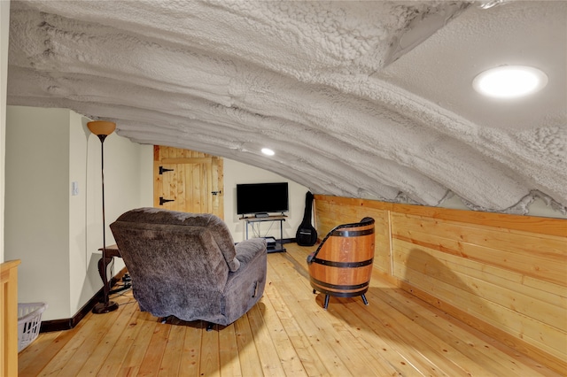 bonus room featuring hardwood / wood-style floors, lofted ceiling, and a textured ceiling