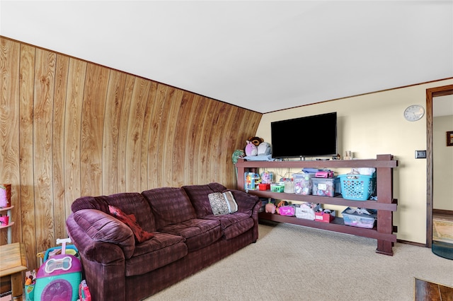 carpeted living room with wooden walls and ornamental molding