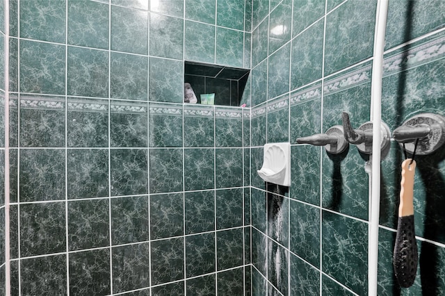 bathroom with a tile shower