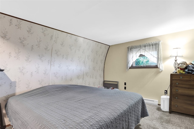 bedroom with baseboard heating and carpet floors