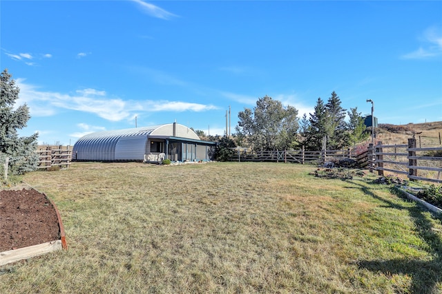 view of yard featuring a rural view and an outdoor structure