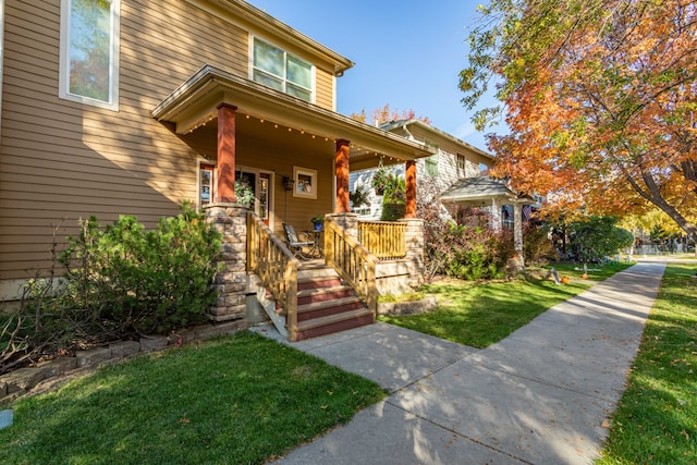 view of front of home featuring a front lawn and covered porch