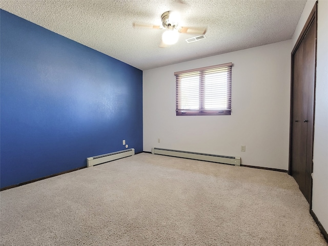 unfurnished room with a textured ceiling, a baseboard radiator, ceiling fan, and light colored carpet