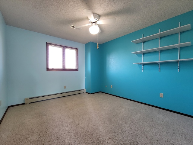 spare room with a textured ceiling, ceiling fan, and a baseboard heating unit