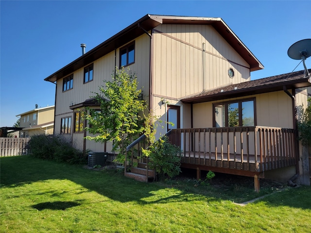 back of house with a deck and a yard