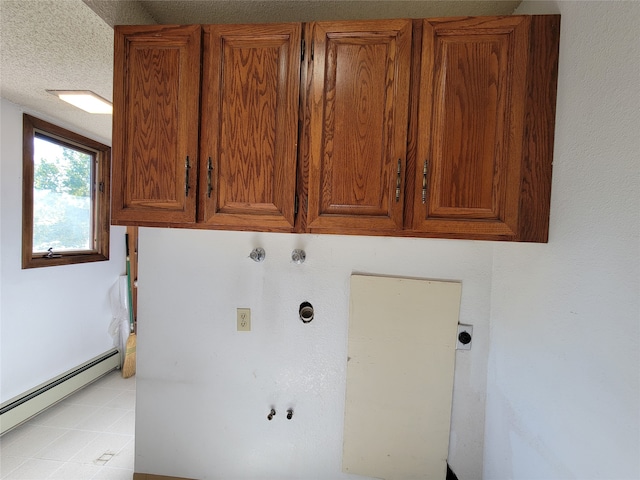 washroom featuring hookup for an electric dryer, cabinets, a textured ceiling, and a baseboard radiator