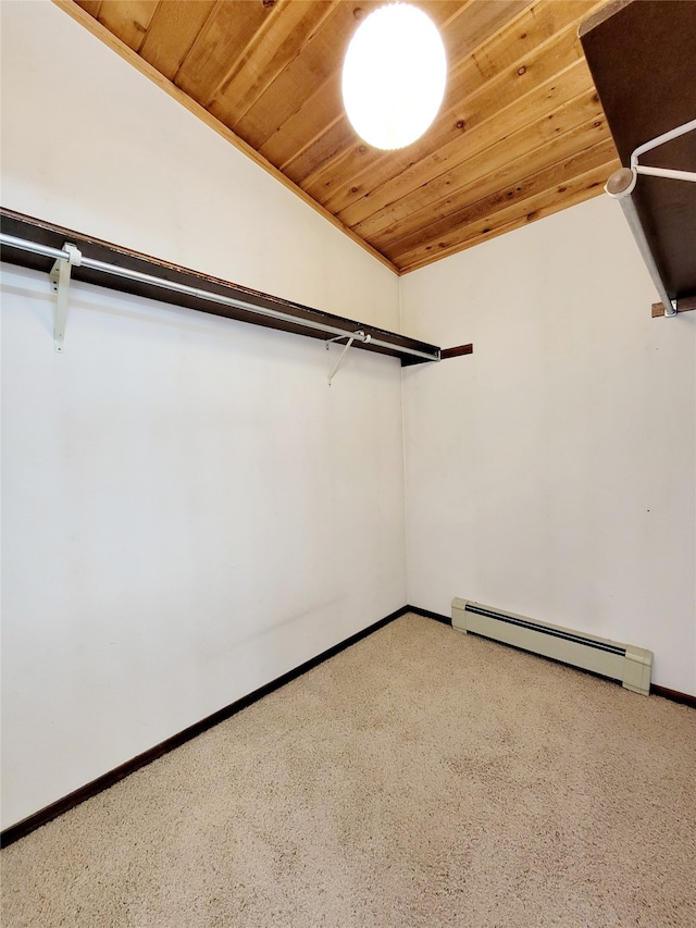 spacious closet with carpet, vaulted ceiling, and a baseboard heating unit