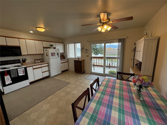 carpeted dining space featuring ceiling fan