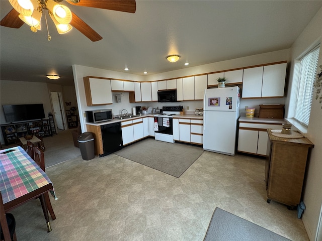 kitchen with black appliances, ceiling fan, and white cabinets