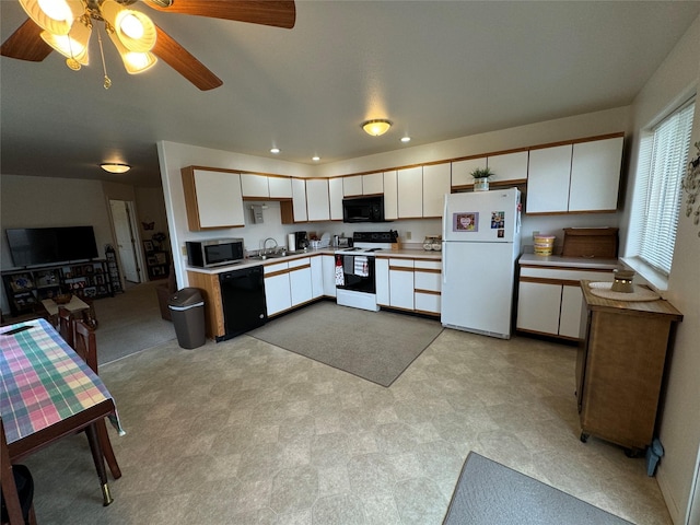 608 Clark St, Deer Lodge, MT 59722 - kitchen with light floors, recessed lighting, light countertops, white cabinets, and black appliances