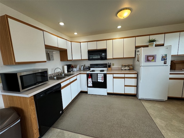 kitchen featuring sink, white cabinetry, and black appliances