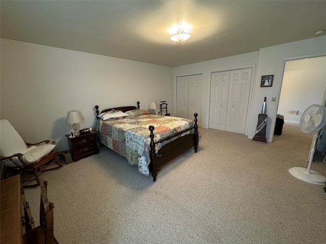 carpeted bedroom with multiple closets