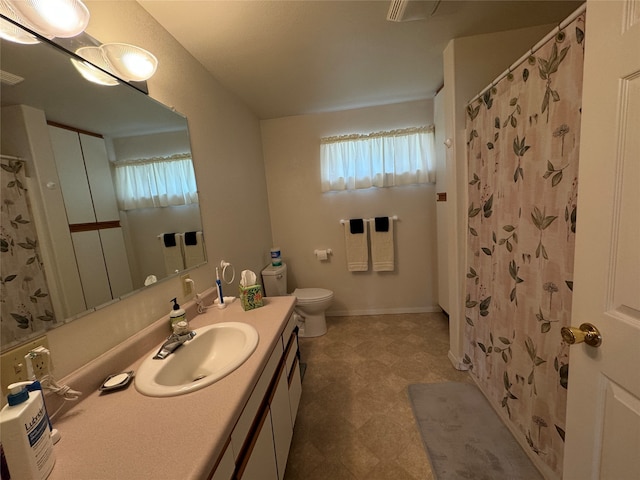 bathroom featuring vanity, toilet, and a shower with shower curtain