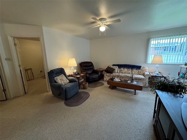 carpeted living room with ceiling fan