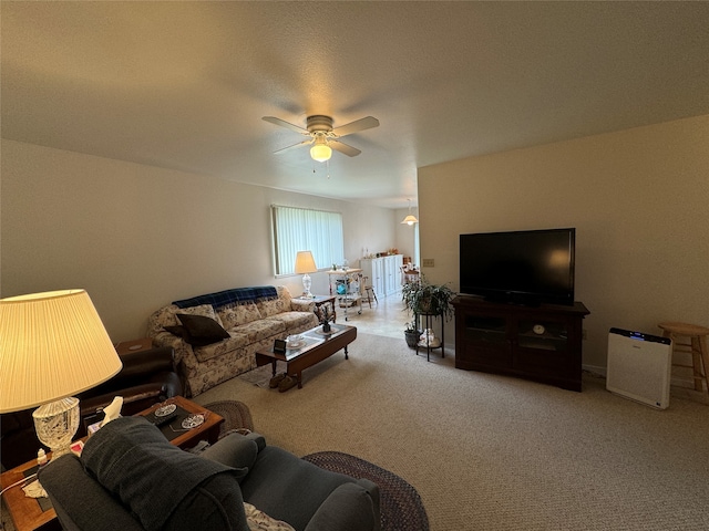 carpeted living room featuring ceiling fan