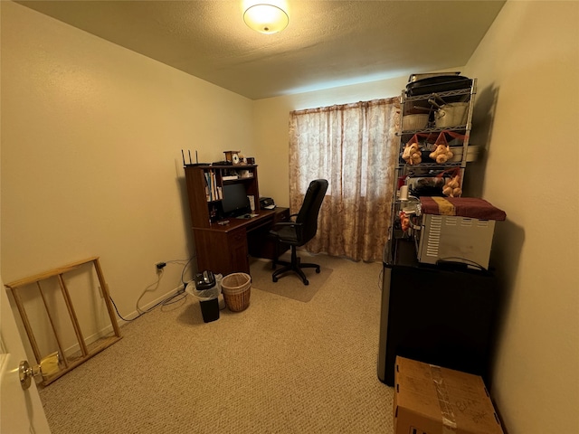 home office with a textured ceiling and carpet flooring