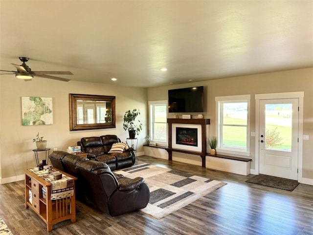 living room with ceiling fan and dark wood-type flooring