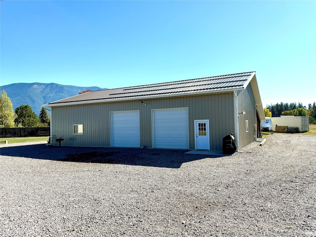 garage featuring a mountain view and wooden walls