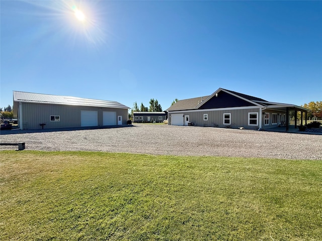 exterior space with a garage and a lawn