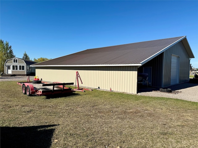 exterior space featuring an outdoor structure, a garage, and a lawn