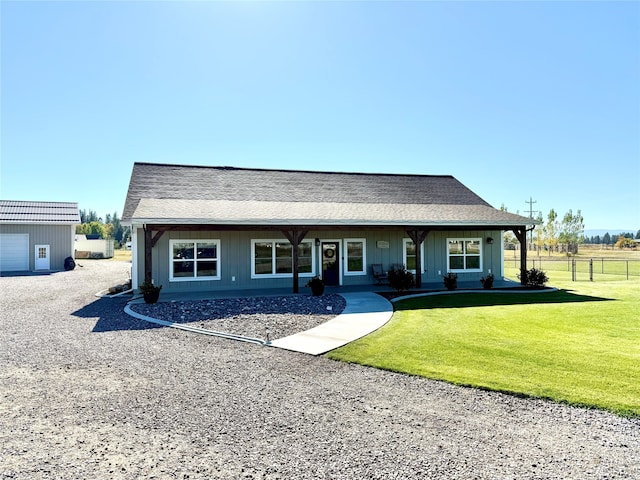 ranch-style home with a front lawn, a porch, and a garage