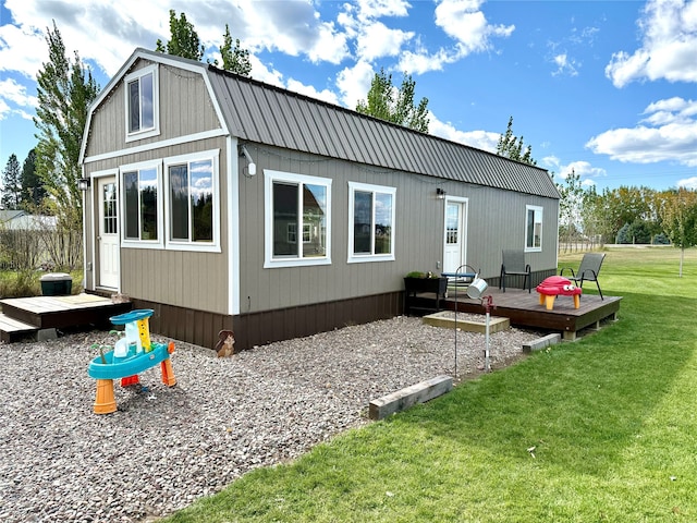 back of house with a deck and a lawn