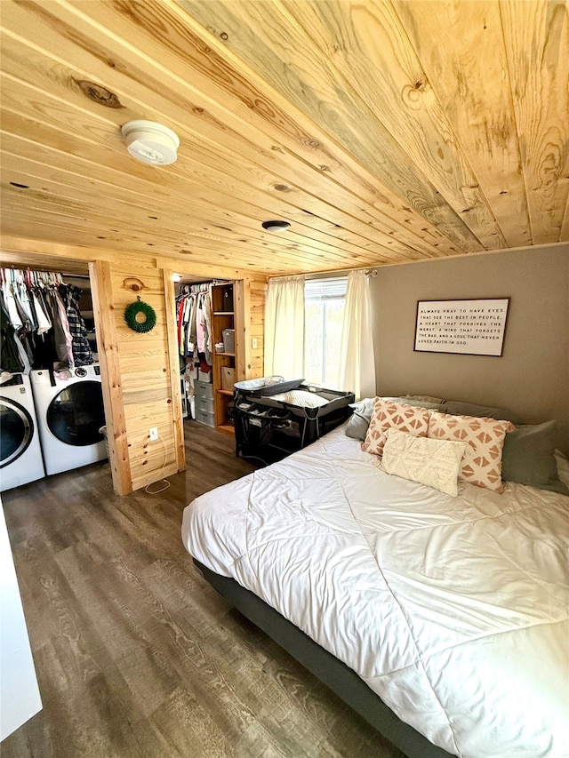 bedroom with washing machine and clothes dryer, dark wood-type flooring, wooden ceiling, and a closet