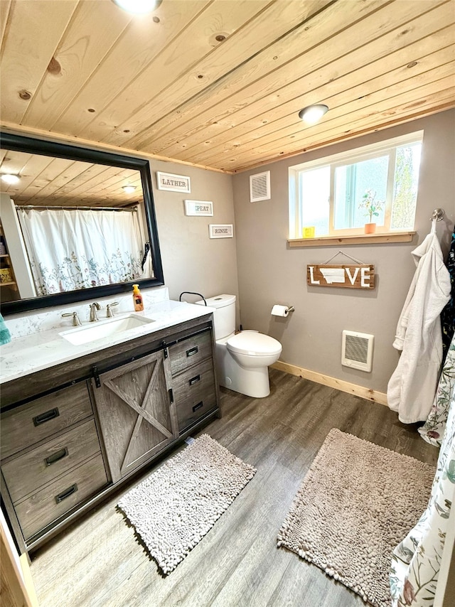 bathroom featuring wooden ceiling, hardwood / wood-style flooring, vanity, and toilet